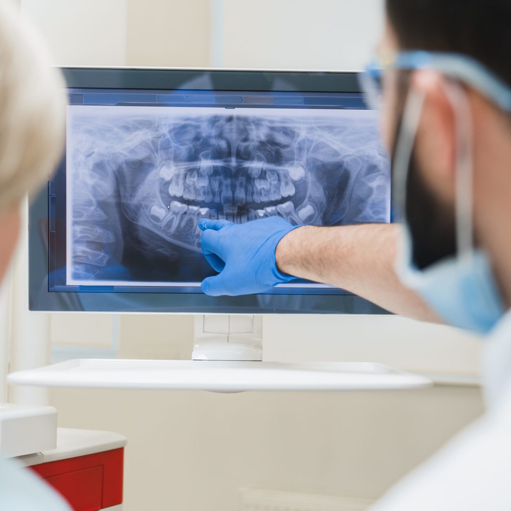 Back,View,Shot,Of,Male,Dentist,Orthodontist,Showing,Explaining,An